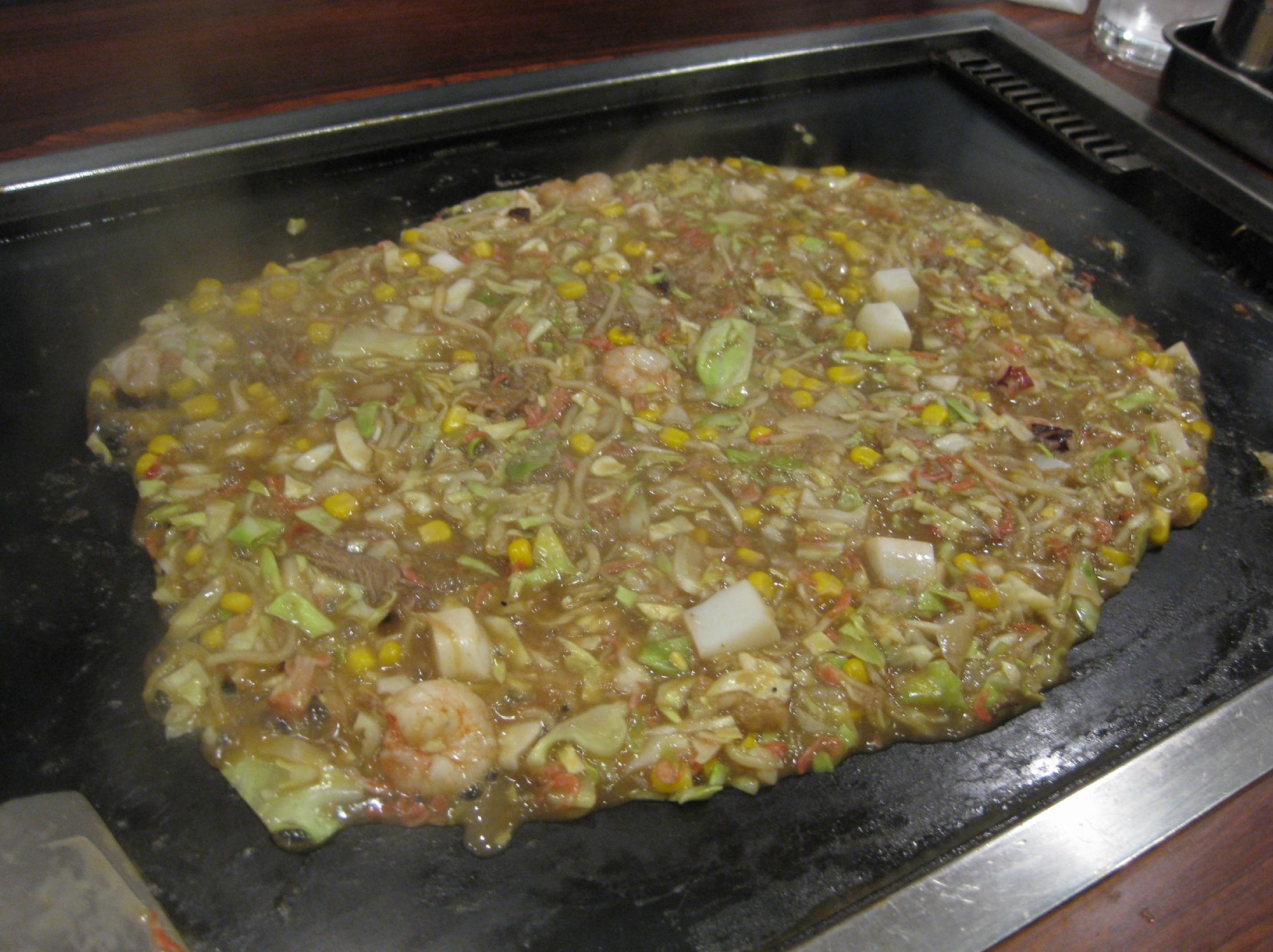 Monjayaki cooking on a griddle in Tsukishima