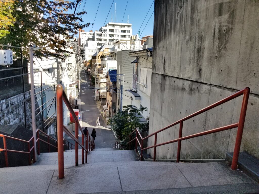 Suga Shrine stairs with red handrails in Yotsuya, Tokyo
