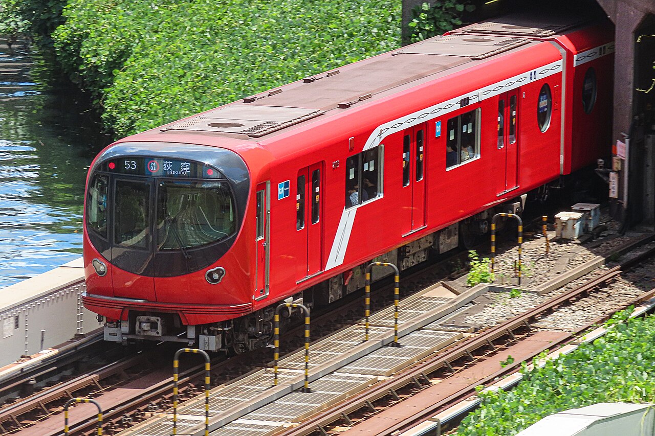 Tokyo Metro Marunouchi Line train emerging beside the Kanda River near Ochanomizu in August 2023